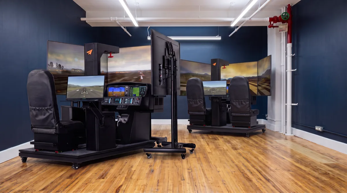 Rendering of the single-seat Vision Jet simulator in front and the two-seat SR-series simulator behind it on a maple floor, both facing their screens