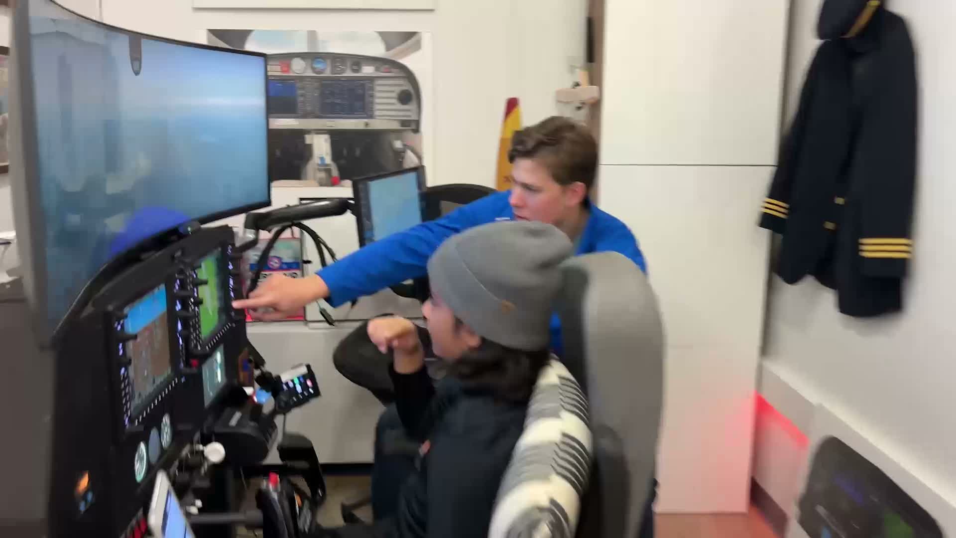 Young aviator learning to fly in flight simulator