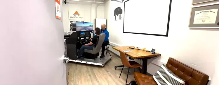 Private pilot training in NYC — student flying the G1000 simulator at Aviator.NYC in Manhattan with an airline pilot instructor.